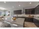 Island kitchen with granite countertops, dark cabinets and stainless steel appliances at 19749 S 231 St. Way, Queen Creek, AZ 85142