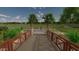 Stone pathway leads through park with lush landscaping and playground at 19749 S 231 St. Way, Queen Creek, AZ 85142