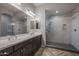 Modern bathroom with double sinks, a large shower, and dark brown cabinets at 19749 S 231 St. Way, Queen Creek, AZ 85142