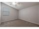 Simple bedroom with carpeted floor, window with blinds, and ceiling fan at 19749 S 231 St. Way, Queen Creek, AZ 85142