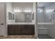 Elegant bathroom with double vanity, marble shower, and wood-look floors at 19749 S 231 St. Way, Queen Creek, AZ 85142