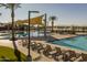 Community pool with shade structures, lounge chairs, and a play area at 19749 S 231 St. Way, Queen Creek, AZ 85142