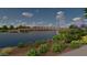 Wooden footbridge over tranquil lake with lush landscaping at 19749 S 231 St. Way, Queen Creek, AZ 85142