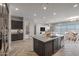 Open concept kitchen with granite island, dark cabinets and stainless steel appliances at 19749 S 231 St. Way, Queen Creek, AZ 85142