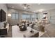Open concept living and dining area with stylish furniture and herringbone floors at 19749 S 231 St. Way, Queen Creek, AZ 85142