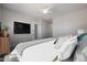 Well-lit bedroom featuring a king-size bed and a large TV at 19749 S 231 St. Way, Queen Creek, AZ 85142