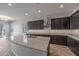 Open kitchen boasting a large island with granite countertops and dark wood cabinetry at 19749 S 231 St. Way, Queen Creek, AZ 85142