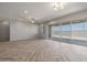Spacious living room featuring herringbone floors and access to a backyard patio at 19749 S 231 St. Way, Queen Creek, AZ 85142