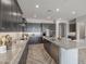 Stylish kitchen with granite countertops, dark cabinetry, and stainless steel appliances at 19749 S 231 St. Way, Queen Creek, AZ 85142