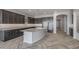 Modern kitchen with granite countertops, stainless steel appliances, and dark wood cabinets at 19749 S 231 St. Way, Queen Creek, AZ 85142