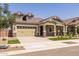 Two-story house with dormer windows, a green-painted garage, and a well-kept lawn at 19749 S 231 St. Way, Queen Creek, AZ 85142