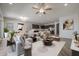 Open living space with stylish sectional sofa and view of the kitchen at 19749 S 231 St. Way, Queen Creek, AZ 85142