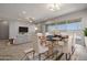 Elegant dining area with a modern table and chairs, overlooking the living room at 19749 S 231 St. Way, Queen Creek, AZ 85142