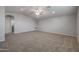 Spacious loft area with neutral carpeting and ceiling fan at 19749 S 231 St. Way, Queen Creek, AZ 85142