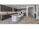 Spacious kitchen featuring a large island with seating, granite countertops, and stainless steel appliances at 19749 S 231 St. Way, Queen Creek, AZ 85142