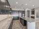 Modern kitchen with granite countertops and dark wood cabinets at 19749 S 231 St. Way, Queen Creek, AZ 85142