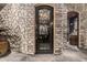 Elegant wine cellar entrance with stonework and wrought iron at 3831 E Huber St, Mesa, AZ 85205