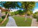 Landscaped backyard with a stone pathway and lush greenery at 3831 E Huber St, Mesa, AZ 85205