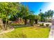 Landscaped backyard with playground, pergola, and spacious grassy area at 3831 E Huber St, Mesa, AZ 85205