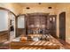 Home office with built-in wooden shelving and a large desk at 3831 E Huber St, Mesa, AZ 85205