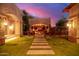 Outdoor area with fire pit, stone walls, and seating under a covered patio at 3831 E Huber St, Mesa, AZ 85205