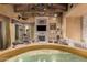 Spacious living room featuring a large stone fireplace and high wood beam ceilings at 3831 E Huber St, Mesa, AZ 85205