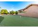 Private putting green surrounded by lush landscaping at 3831 E Huber St, Mesa, AZ 85205