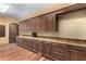 Long kitchen with ample wood cabinetry and granite countertops at 3831 E Huber St, Mesa, AZ 85205