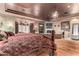 Bright main bedroom with a large bed and hardwood floors at 3831 E Huber St, Mesa, AZ 85205