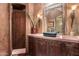 Elegant bathroom with dark vanity and ornate mirror at 3831 E Huber St, Mesa, AZ 85205