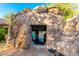Unique rock grotto pool feature with stairs at 3831 E Huber St, Mesa, AZ 85205