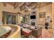 Spacious living room with a stone fireplace, high ceilings, and exposed beams at 3831 E Huber St, Mesa, AZ 85205