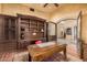 Home office with built-in wood shelving and a large desk at 3831 E Huber St, Mesa, AZ 85205
