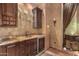 Convenient wet bar with granite countertop and cabinetry at 3831 E Huber St, Mesa, AZ 85205