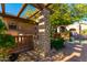 Stone outdoor shower with a pergola, next to the pool at 3831 E Huber St, Mesa, AZ 85205