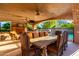 Covered patio with dining table and pool view at 3831 E Huber St, Mesa, AZ 85205