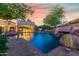 Luxury pool and outdoor kitchen area with stunning sunset view at 3831 E Huber St, Mesa, AZ 85205