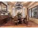 Elegant dining room with a large wood table and chandelier at 3831 E Huber St, Mesa, AZ 85205