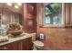 Bathroom with copper sink, wood vanity, and a window at 3831 E Huber St, Mesa, AZ 85205