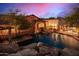 Luxury pool and backyard with rock waterfall and lounge chairs at 3831 E Huber St, Mesa, AZ 85205