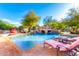 Sparkling pool with a rock waterfall and lounge chairs at 3831 E Huber St, Mesa, AZ 85205