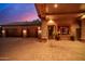 Attached garage with wooden doors and stone exterior at night at 3831 E Huber St, Mesa, AZ 85205