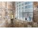 Shower with glass block window and stone tile surround at 3831 E Huber St, Mesa, AZ 85205