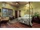 Spacious bedroom with four poster bed and wood floors at 3831 E Huber St, Mesa, AZ 85205