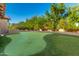 Putting green with sand trap and mature trees at 3831 E Huber St, Mesa, AZ 85205
