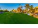 Landscaped green space with a pond and condo buildings in the background at 7930 E Camelback Rd # 506, Scottsdale, AZ 85251