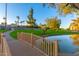 Wooden footbridge over a calm pond with lush greenery and pathway at 7930 E Camelback Rd # 506, Scottsdale, AZ 85251