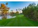 Picturesque golf course with a pond and palm trees in the background at 7930 E Camelback Rd # 506, Scottsdale, AZ 85251