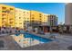 Inviting community pool with surrounding lounge chairs and building view at 7930 E Camelback Rd # 506, Scottsdale, AZ 85251