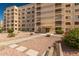 Condo building exterior with walkway and landscaping, showing building access at 7930 E Camelback Rd # 506, Scottsdale, AZ 85251